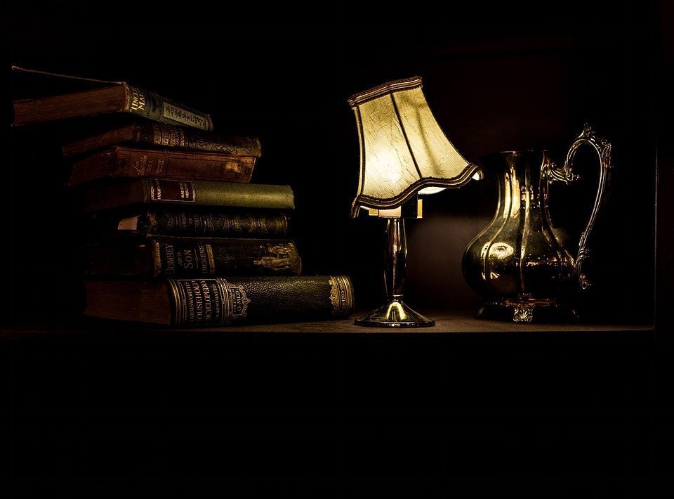 Books on table with lamp